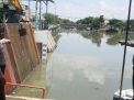 Antisipasi Banjir, Unit Lantas & Unit Sabhara Polsek Kenjeran Pantau Ketinggian Air di Sungai Tambak Wedi
